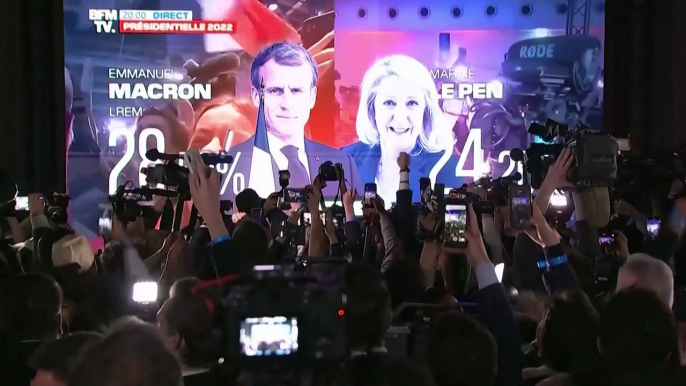 Emmanuel Macron and Marine Le Pen supporters celebrate as candidates get through to second round of French election