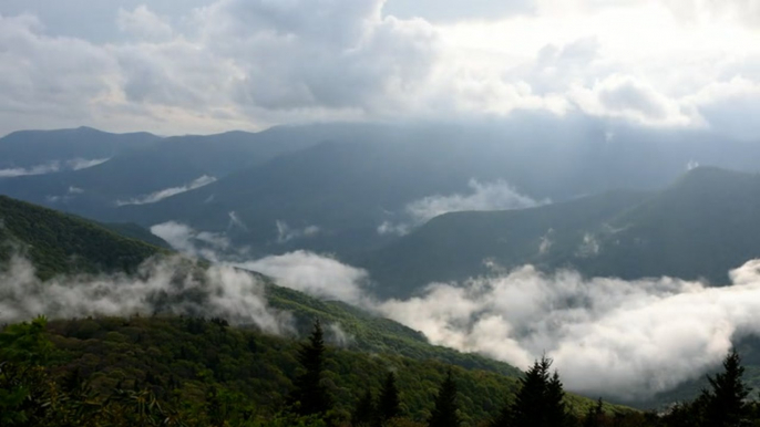 Clouds push through mountains