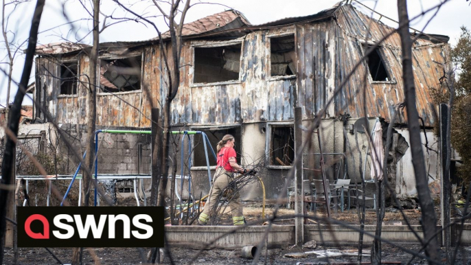 Grim scenes of scorched fields and burned-out buildings after fire rips through London suburb