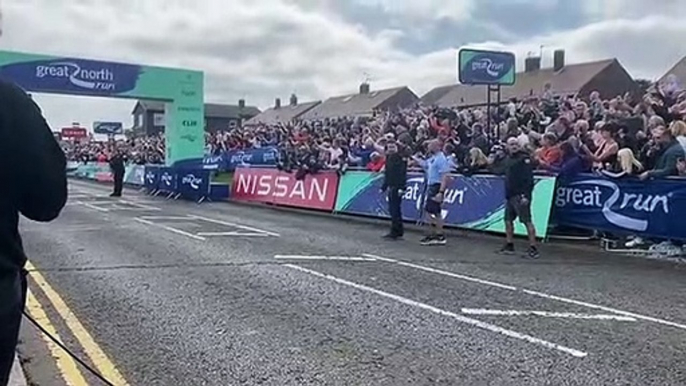 Applause at the Great North Run finish line as the Elite Men's winner completes the race