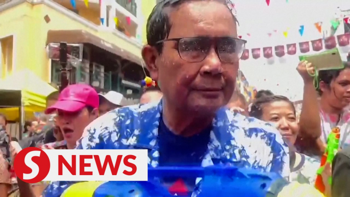 Thai PM gets soaked in surprise water fight appearance