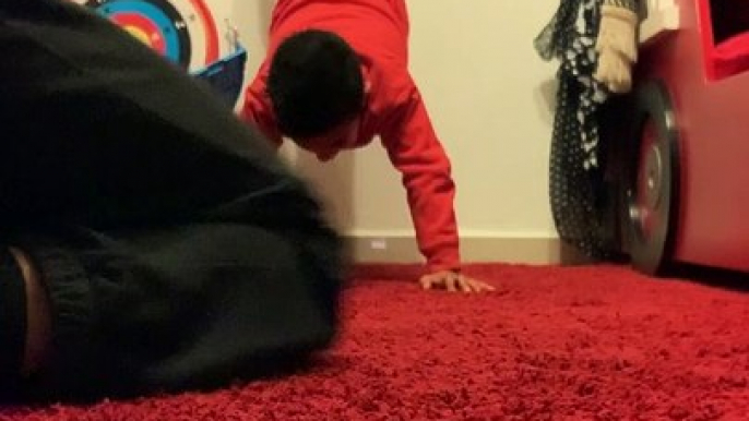 Boy punches his dad in a sensitive area as he does a handstand