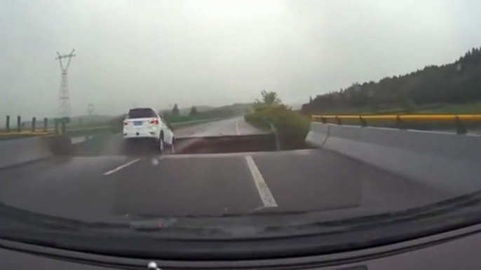 Car plunges off bridge into riverbank as driver fails to notice gaping hole