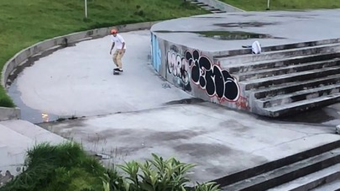 Skateboarder ollies set of stairs and lands on his ankle