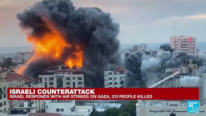 Gazans walk through rubble of their homes after Israeli airstike