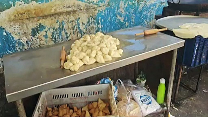 Food is prepared for passengers at the station amid filth