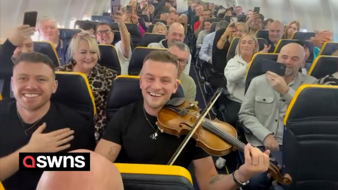 Fiddle playing folk musician entertains plane passengers