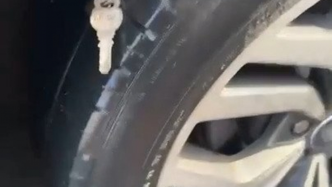 Keys Puncture Tire of Moving Car on Road