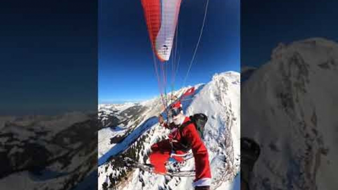 Paraglider Wearing Santa Costume Flies Down Snowy French Alps