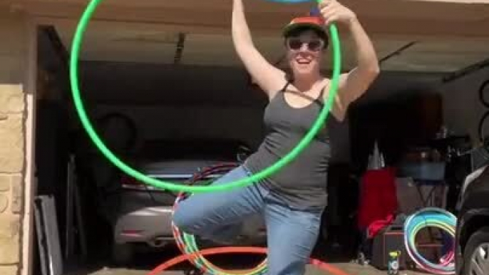 Circus Artist Shows Multiple Tricks Using Three Hula Hoops