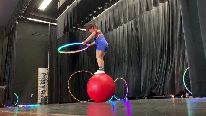 Woman Performs Scary Trick With Ball and Hoop on Stage