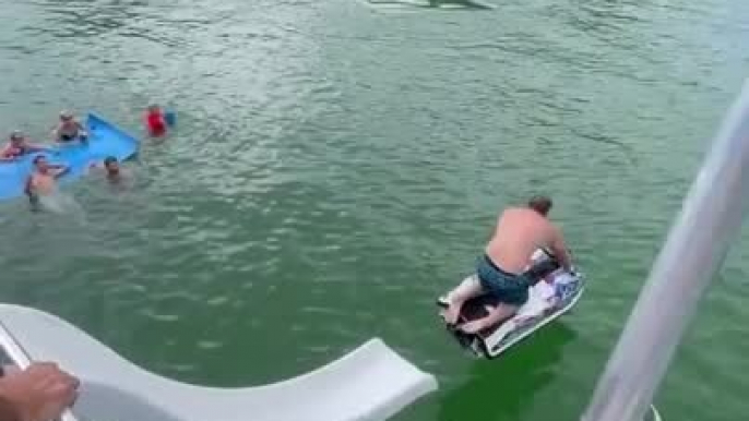 Person Falls Into Water While Trying to Take Jet Ski Down Houseboat Slide