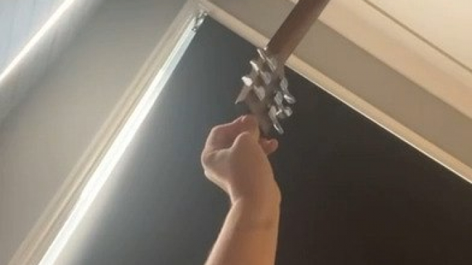 Man's epic guitar balancing act hits the roof