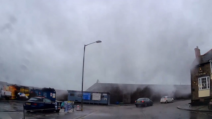 Huge Wave Strikes Coastal Wall in Newlyn, Cornwall and Drenches Passing Vehicle